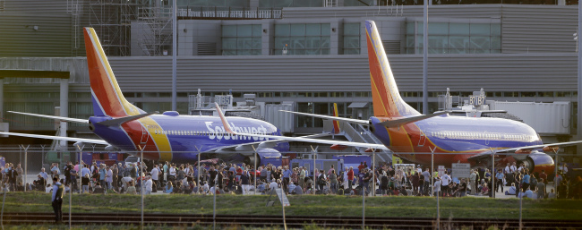 Passengers wait on the tarmac at Fort Lauderdale-Hollywood International Airport after a gunman opened fire in the baggage claim area at the airport on Friday. (AP-Yonhap)