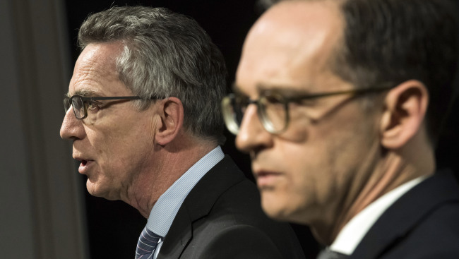 Germany's Interior Minister Thomas de Maizi're, left, and Justice Minister Heiko Maas attend a joint news conference in Berlin, Germany, Tuesday. (Bernd von Jutrczenka/dpa via AP)/