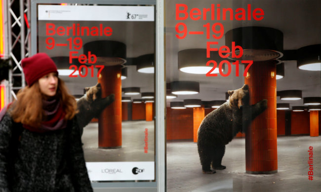 A pedestrian walks by advertising posters for the upcoming 67th Berlin International Film Festival Berlinale near the festival cinema in Berlin, Germany, on Wednesday. Reuters-Yonhap