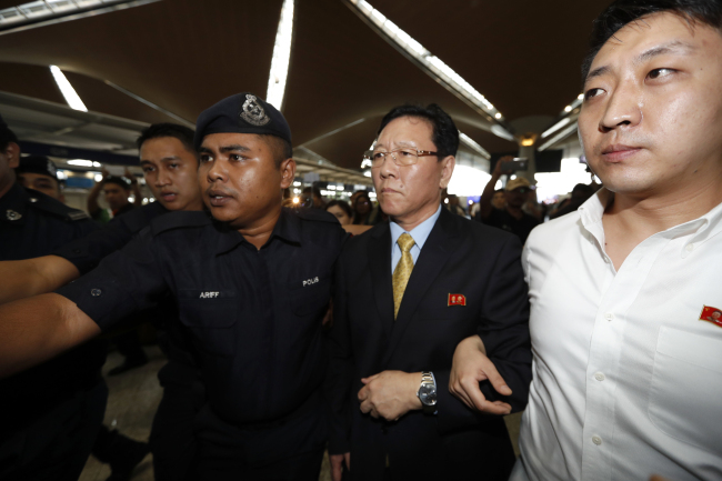 North Korean Ambassador to Malaysia Kang Chol, second from right, arrives at Kuala Lumpur International Airport in Sepang, Malaysia, Monday. (AP)