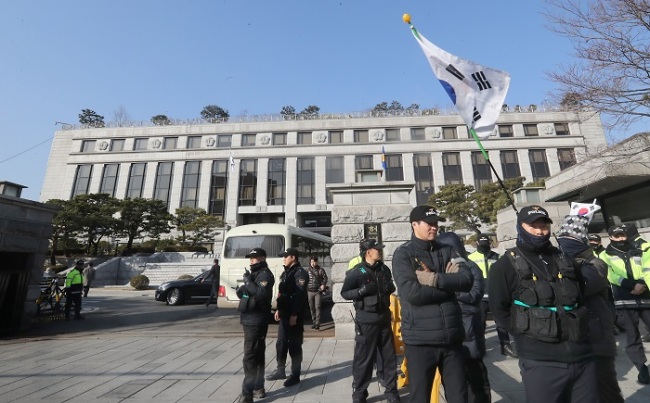 Police guard the Constitutional Court in Seoul on Thursday, ahead of the final ruling Friday in President Park Geun-hye’s impeachment trial. (Yonhap)