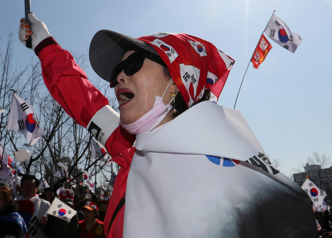 A Park supporter cries as she protests against the Constitutional Court's decision to impeach Park (Yonhap)
