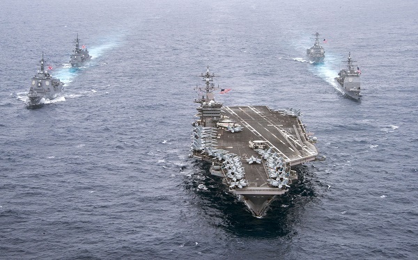 USS Carl Vinson (center), a US aircraft carrier, leads the Japan Maritime Self-Defense Force vessels during a joint exercise. (US Navy)