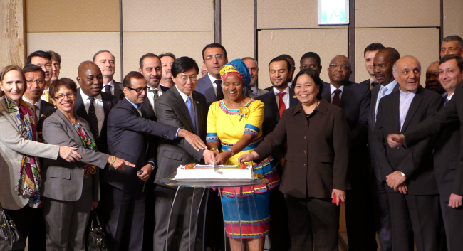 South African Ambassador to Korea Nozuko Gloria Bam (center in a yellow dress) poses with envoys of other countries at a reception marking Freedom Day in Seoul on Thursday. (Joel Lee/The Korea Herald)