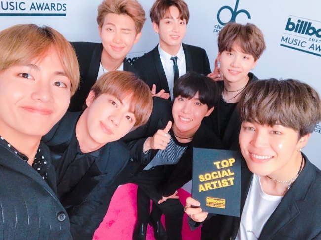 BTS shows excitement over winning the top social artist award through a group photo. (BTS’ Twitter)