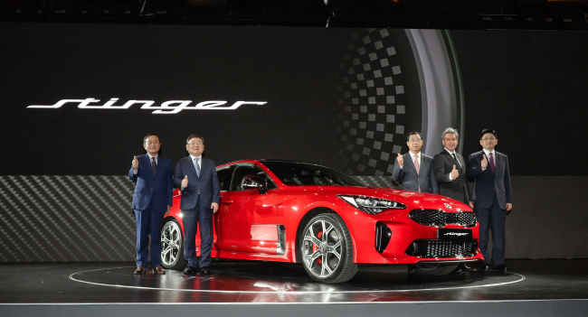 Kia Motors officials on Tuesday present their first-ever high-performance sports sedan, named the Stinger. (Hyundai Motor Group)