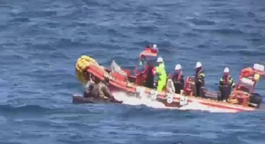 In this file photo, South Korean Coast Guard officers rescue six North Korean sailors in the East Sea on May 27, 2017. They all returned to the North last week. (Yonhap)