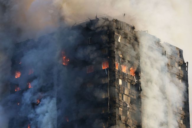 The massive fire ripped through the 27-storey apartment block in west London in the early hours of Wednesday, trapping residents inside as 200 firefighters battled the blaze. (AFP-Yonhap)