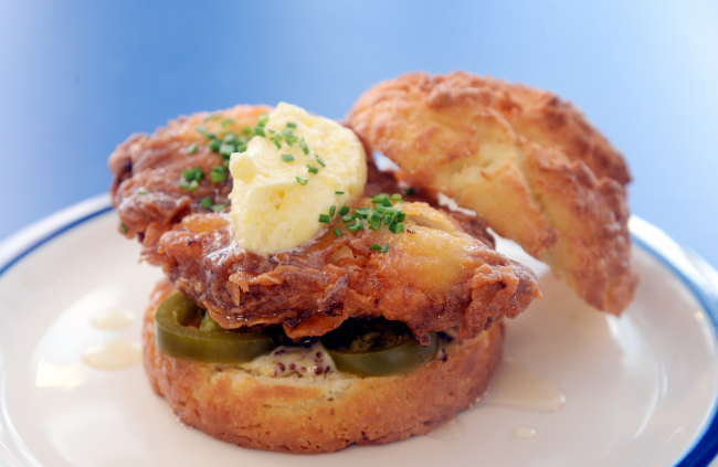 Buttermilk Biscuit Co.‘s honey butter sandwich features fried chicken breast topped with honey butter and swaddled in a biscuit dressed with whole grain mustard and mayo and garnished with jalapenos. (Photo credit: Park Hyun-koo/The Korea Herald)