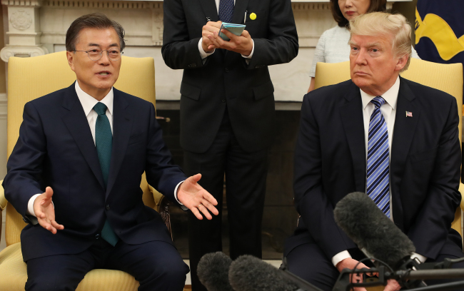 President Moon Jae-in (left) speaks at the outset of his summit with US President Donald Trump (right) at the White House in Washington on Friday. (Yonhap)