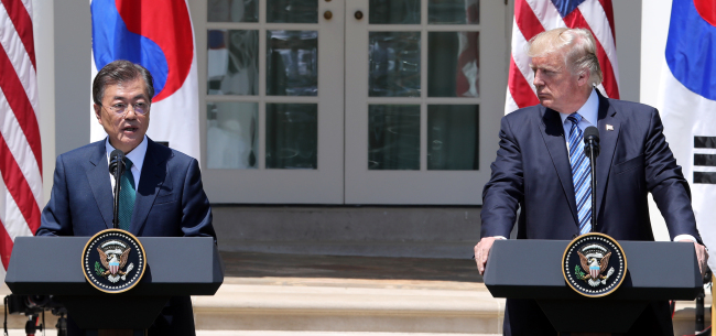 President Moon Jae-in (left) and his US counterpart Donald Trump speak in a joint press briefing on Friday, following their summit. (Yonhap)