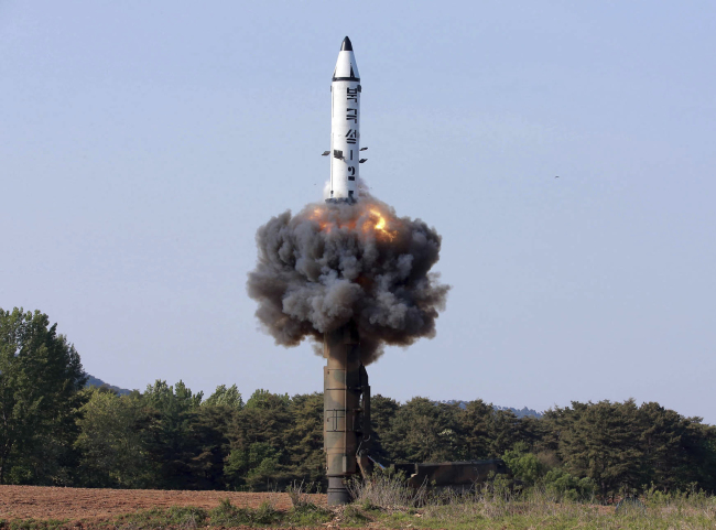 In this undated file photo released by North Korean state media on May 22, the Pukguksong-2 missile lifts off during a test. (AP-Yonhap)