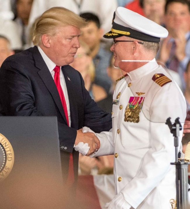 President Donald Trump (left) shakes hands with Capt Richard McCormack, USN after assuming command of The Gerald R. Ford during the commissioning ceremony at Norfolk Naval Base, Virginia on Saturday. UPI-Yonhap