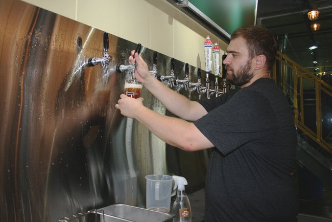 Frederic Huyssen pours a beer at the Ranch Brewing Co.’s brewery in Daejeon. (Chantelle Yeung)