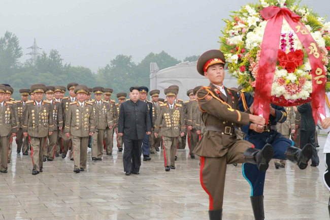 This image released Friday by state media shows North Korean leader Kim Jong-un visiting a cemetery to commemorate fallen veterans during the 1950-53 Korean War, marking the armistice anniversary on Thursday. It was his first public appearances in 15 days. (Yonhap)