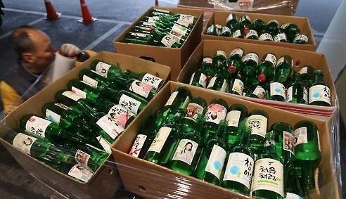 This undated file photo shows empty bottles being collected at a shop. (Yonhap)