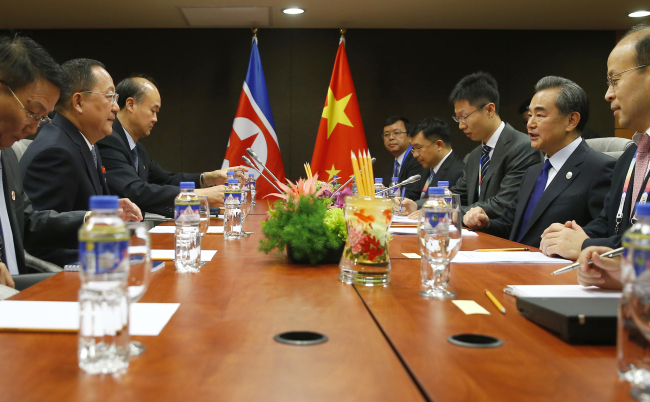 North Korean Foreign Minister Ri Yong Ho, second from left, prepares for a meeting with his Chinese counterpart Wang Yi, second from right, in the sidelines of the 50th ASEAN Foreign Ministers' Meeting and its Dialogue Partners. (AP-Yonhap)