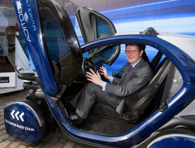 Greg Clark MP, UK secretary of state for business, energy and industrial strategy, sits in a self-driving pod at the “SMMT Connected” event in London on March 20. (Anthony Upton/PA Wire)