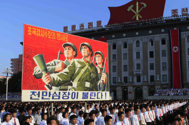 North Koreans stage a rally in Pyongyang on Thursday. (AP-Yonhap)