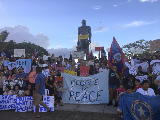 About a hundred people gather at Chief Kepuha Park in Hagatna, Guam for a rally for peace Monday. (AP-Yonhap)
