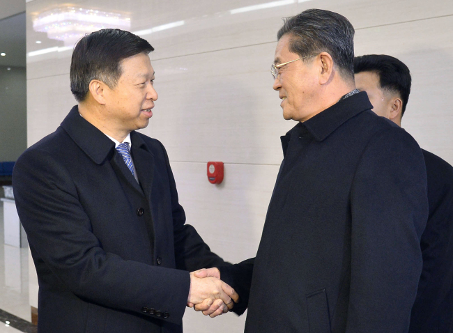 Song Tao (left), shakes hands with Ri Chang-gun (right), a high-ranking North Korean official upon his arrival in Pyongyang. (Yonhap)