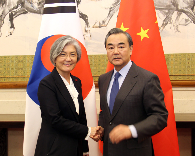 Foreign Minister Kang Kyung-wha meets her Chinese counterpart Wang Yi in Beijing on Wednesday. (Yonhap)