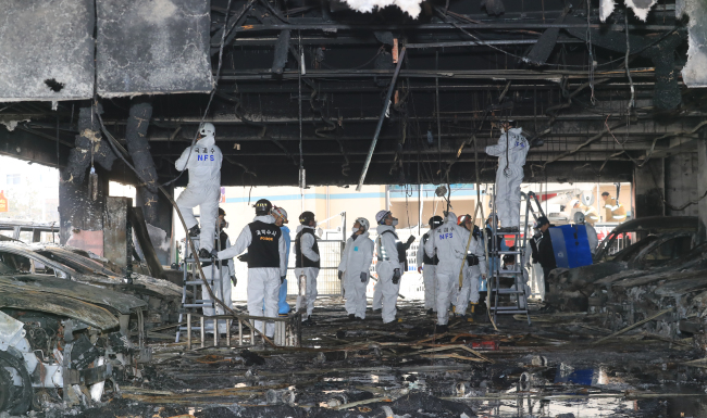 Officials from the National Forensics Service and fire authorities conduct a forensic examination of the scene of a major blaze that broke out in an eight-story building in the southern city of Jecheon in North Chungcheong Province on Thursday. Yonhap