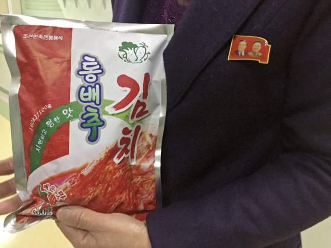 In this Dec. 20, 2017, photo, manager Paek Mi Hye holds a package of kimchi produced at the Ryugyong Kimchi Factory on the outskirts of Pyongyang, North Korea. The factory is a showcase of North Korean leader Kim Jong Un’s efforts to boost the country’s domestic economy and produce more, and better, consumer products. The strategy, known as “byungjin,” is intended to simultaneously develop the national economy and North Korea’s nuclear weapons program. (AP)