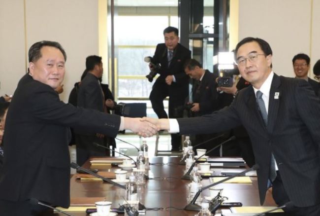 South Korean Unification Minister Cho Myoung-gyon, right, shakes hands with the head of North Korean delegation Ri Son Gwon before their meeting at the Panmunjom in the DMZ in Paju, South Korea, Tuesday, Jan. 9, 2018. (AP-Yonhap)