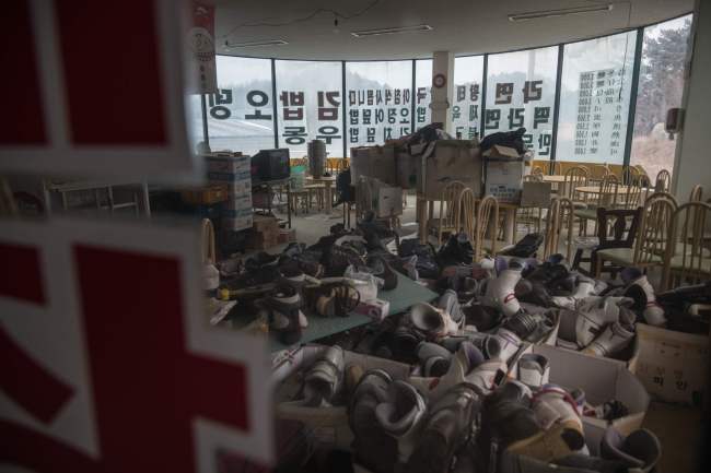 This photo taken on January 16, 2018 shows ski boots piled up in a former restaurant the abandoned Alps Ski Resort. (AFP-Yonhap)