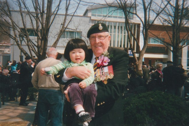 Korean War veteran and former PPCLI soldier Jim Moore poses with a Korean girl he met at a commemorative ceremony for Canada's participation in the war in South Korea in 2010. Moore met the anonymous child and said he has not forgotten her since. Meeting the girl eraced doubts in his mind as to whether he made any difference in the war, he told The Korea Herald. Moore says he is still looking for the girl to maintain correspondence. (Dennis Moore)
