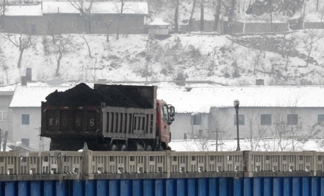 A coal truck crosses the North Korea-China border. (Yonhap)