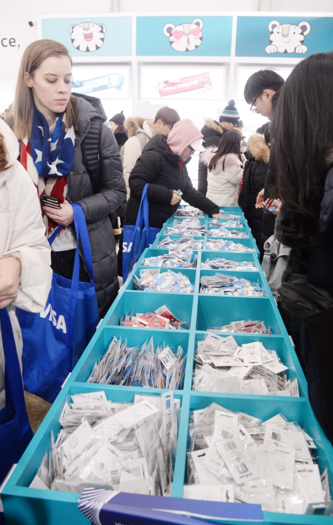 Visitors look at Olympic pins at Super Store in Gangneung Olympic Park. (Park Hyun-koo/The Korea Herald)