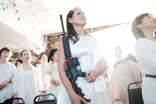 A woman holds an AR-15 rifle during a ceremony at the World Peace and Unification Sanctuary on February 28, 2018 in Newfoundland, Pennsylvania. (AFP-Yonhap)
