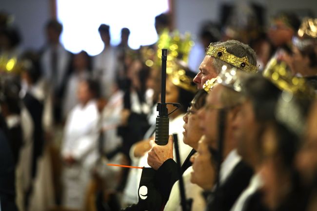 Couples hold AR-15 rifles and other guns during a ceremony at the World Peace and Unification Sanctuary on February 28, 2018 in Newfoundland, Pennsylvania. The controversial church, which is led by the son of the late Rev. Sun Myung Moon, believes the AR-15 symbolizes the 