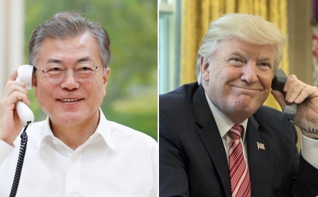 South Korean President Moon Jae-in, left, talks on the phone late Thursday with US counterpart Donald Trump. (Yonhap)
