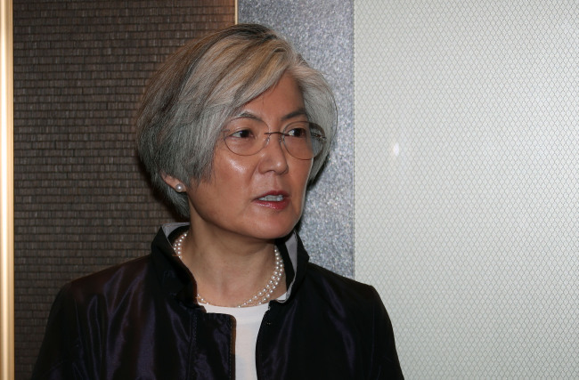 Foreign Minister Kang Kyung-wha answers questions from reporters on her way to the Foreign Ministry building on Wednesday morning. (Yonhap)