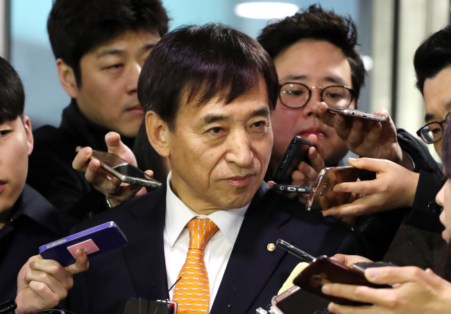 Bank of Korea Gov. Lee Ju-yeol talks to reporters on his way to work Thursday, the day after the US Fed announced a key rate hike. (Yonhap)