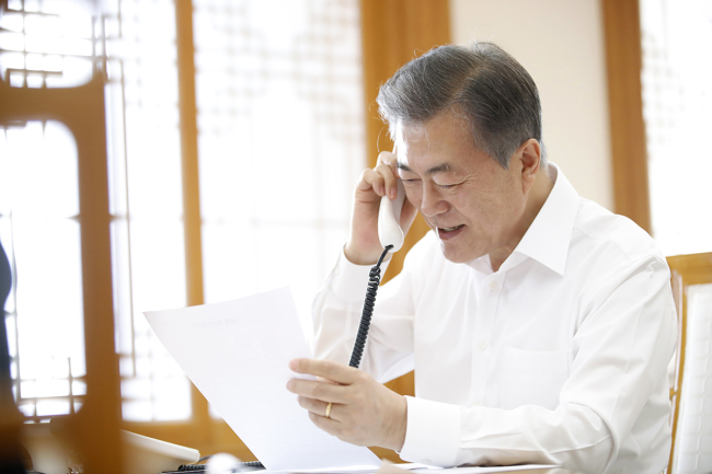 A file photograph from Feb. 15 shows President Moon Jae-in having a telephone conversation. Cheong Wa Dae