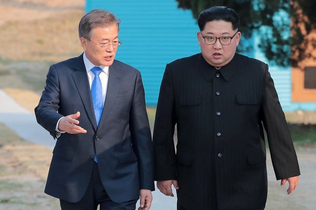 South Korean President Moon Jae-in and North Korean leader Kim Jong Un walk together at the truce village of Panmunjom inside the demilitarized zone separating the two Koreas, South Korea, April 27. (Reuters)
