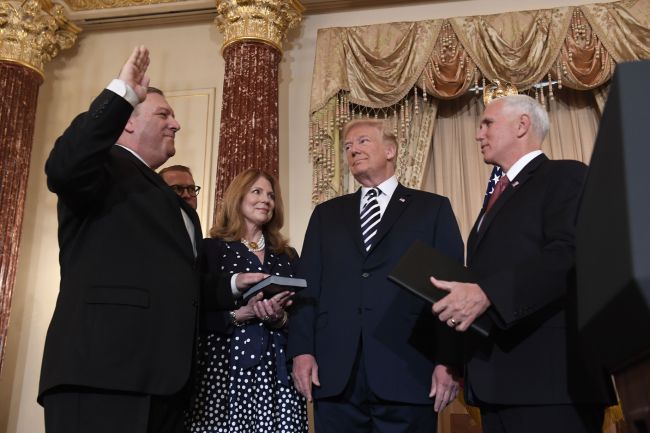 US President Donald Trump watches Mike Pompeo(left) take the oath during his ceremonial swearing-in as US Secretary of State, as Susan Pompeo, Nick Pompeo(2nd from left) and US Vice President Mike Pence (right) look on at the State Department in Washington, DC, May 2, 2018. (AFP-Yonhap)