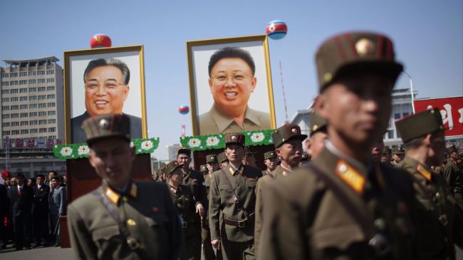 North Korean soldiers attend the opening of the Ryomyong residential area, while in the background, portraits of late North Korean leaders Kim Il Sung and Kim Jong Il are seen, on April 13, 2017, in Pyongyang, North Korea. (AP)