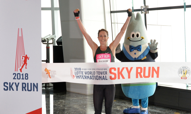 Suzy Walsham, a vertical runner from Australia, celebrates coming in first place among women participants at the 2018 Lotte World Tower International Sky Run.