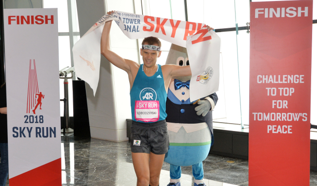 Piotr Lobodzinski, a vertical runner from Poland, celebrates coming in first place among male participants in the 2018 Lotte World Tower International Sky Run.