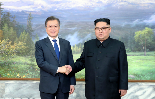 South Korea President Moon Jae-in shakes hands with North Korean leader Kim Jong-un ahead of their summit meeting held at the northern side of Panmunjeom on Saturday. (Cheong Wa Dae-Yonhap)