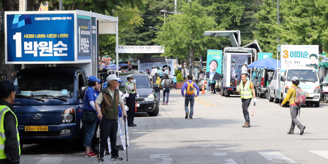 Canvassing trucks are parked in front of the entrance to the Dobongsan trail in Seoul on Sunday. (Yonhap)