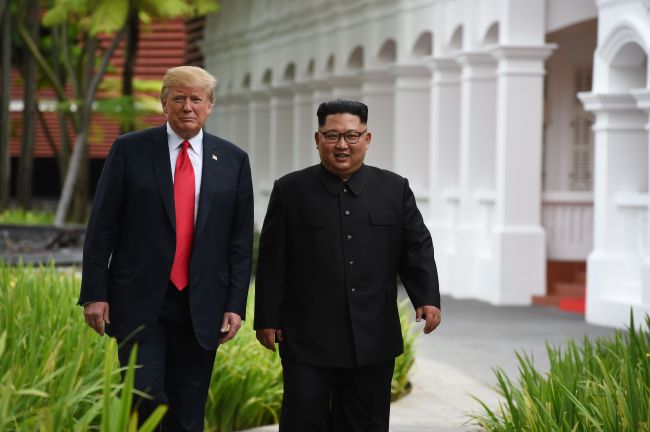 Trump and Kim take a walk near Capella Hotel during the historic summit on Tuesday. (AP-Yonhap)