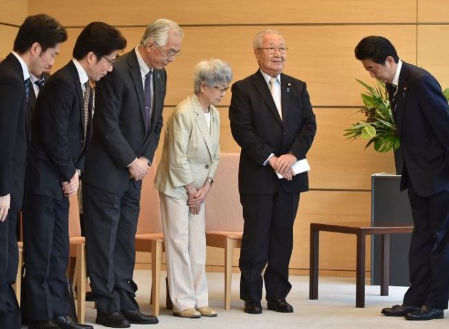 Japan`s Prime Minister Shinzo Abe (R) meets family members of victims abducted to North Korea at the Prime Minister`s official residence in Tokyo, Japan, on Thursday. (Reuters)