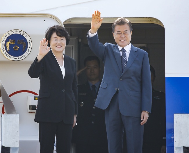 President Moon Jae-in and his wife, Kim Jung-sook, wave before boarding Air Force One to embark on a three-day state visit to Russia on Thursday. (Yonhap)