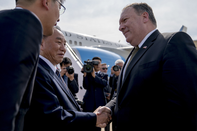 US Secretary of State Mike Pompeo, right, says goodbye to Kim Yong Chol, a North Korean senior ruling party official and former intelligence chief, before boarding his plane at Sunan International Airport in Pyongyang, North Korea, on July 7 to travel to Japan. (AP-Yonhap)